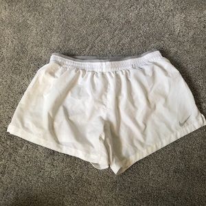White Nike running shorts